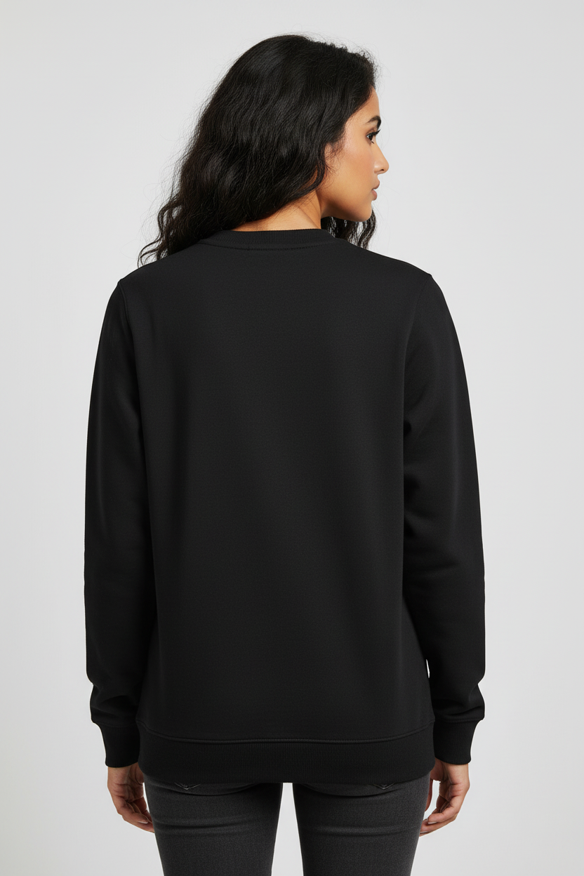 Back view of woman wearing plain black long sleeve sweatshirt and dark jeans against white background