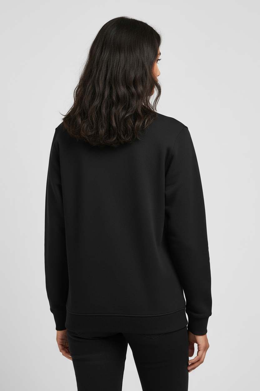 Woman with wavy dark hair wearing a plain black sweatshirt and black pants, back view