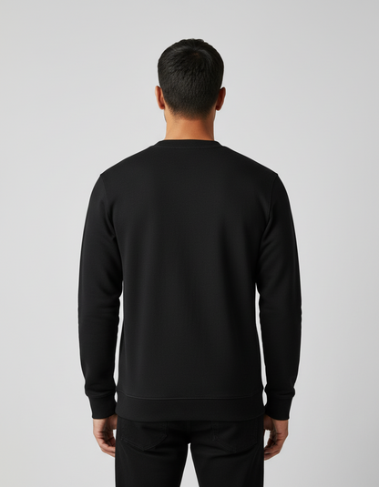 Rear view of man wearing plain black sweatshirt and black pants on gray background