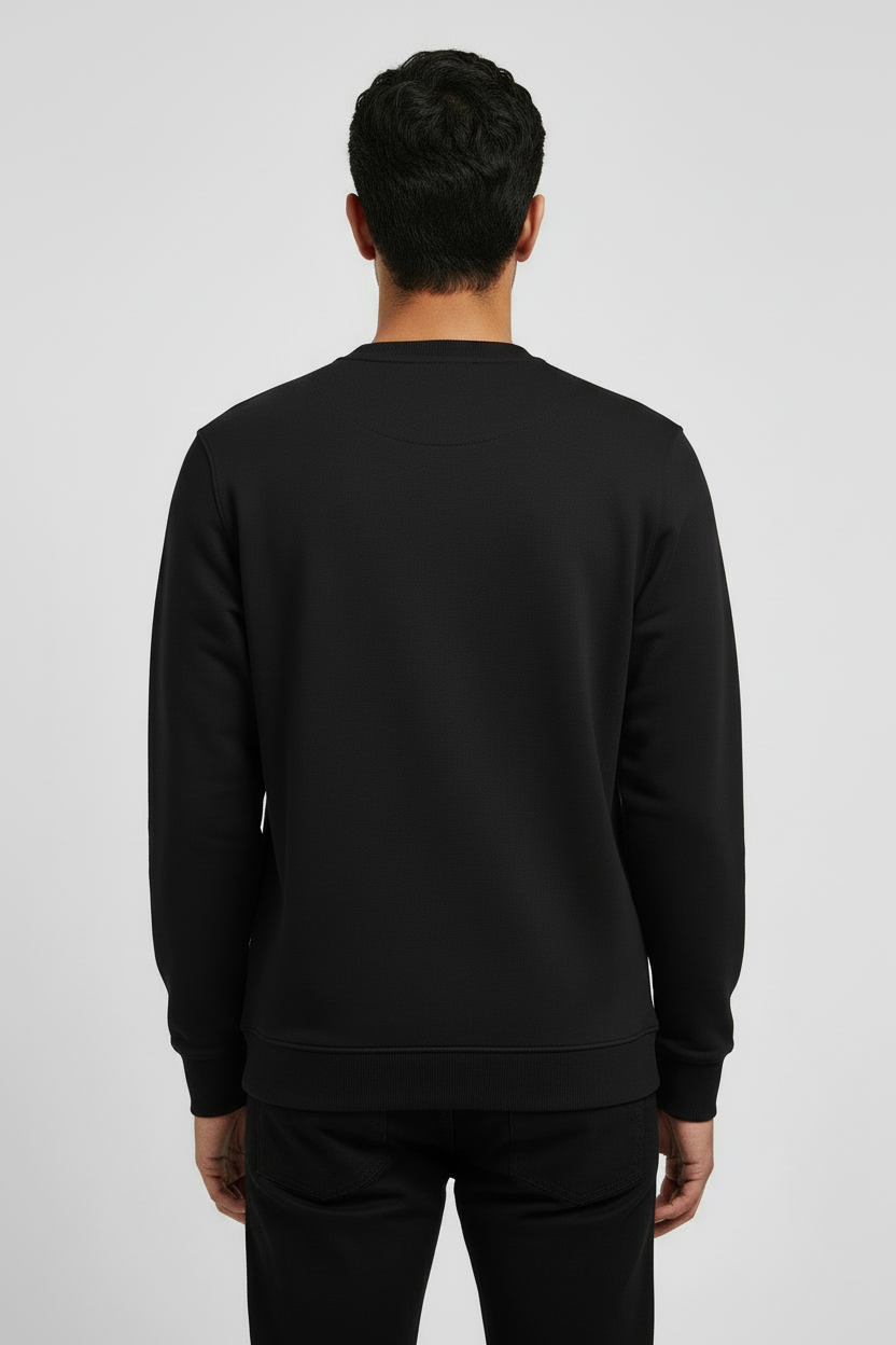 Man wearing a plain black sweatshirt and black jeans, viewed from the back