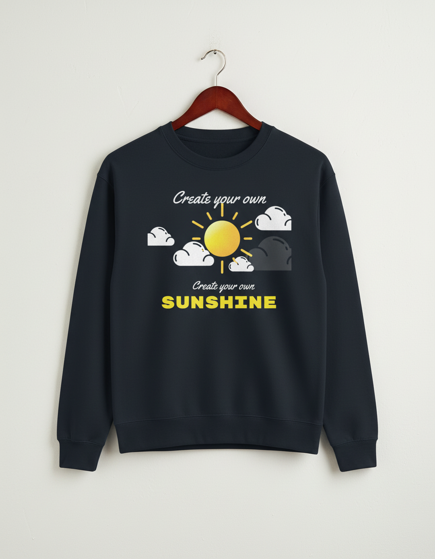 Black crewneck sweatshirt with sun and clouds graphic and text 'Create your own SUNSHINE' hanging on wooden hanger