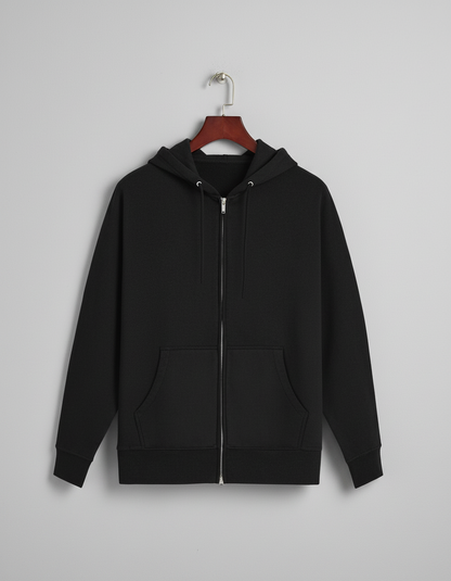 Black zip-up hoodie with front pockets hanging on wooden hanger against gray wall